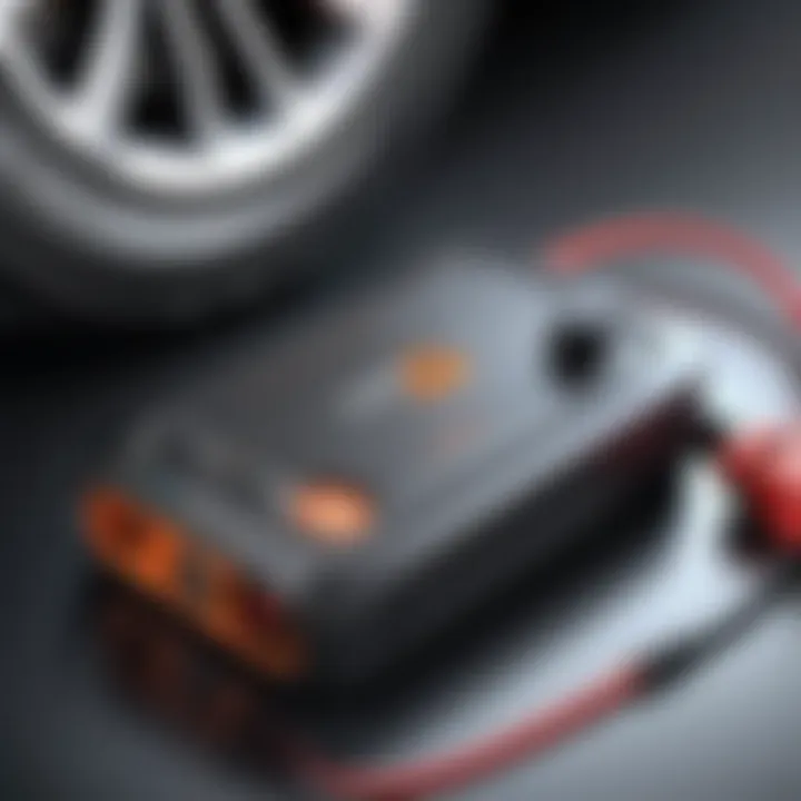 Close-up of a car jump starter with integrated tire inflator, showcasing its design