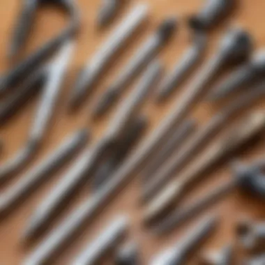 Close-up view of various screw extractor tools arranged on a wooden surface