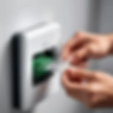 A technician installing a telephone adaptor plug into a device.